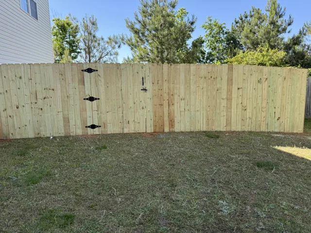 Wood privacy fence with a walk-through gate